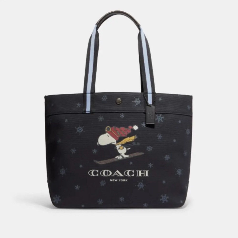 Like new, cute, festive lrg Peanuts Coach X tote w/ Snoopy motif from 22’ line
